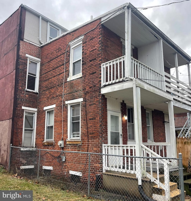 view of side of home with a balcony