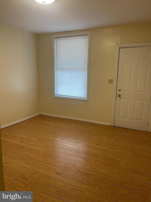 spare room featuring light wood-type flooring