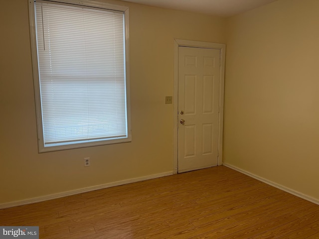 empty room with light hardwood / wood-style floors