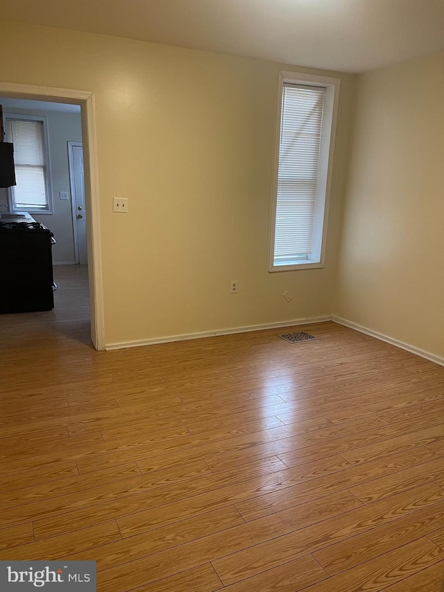 unfurnished room featuring light hardwood / wood-style floors