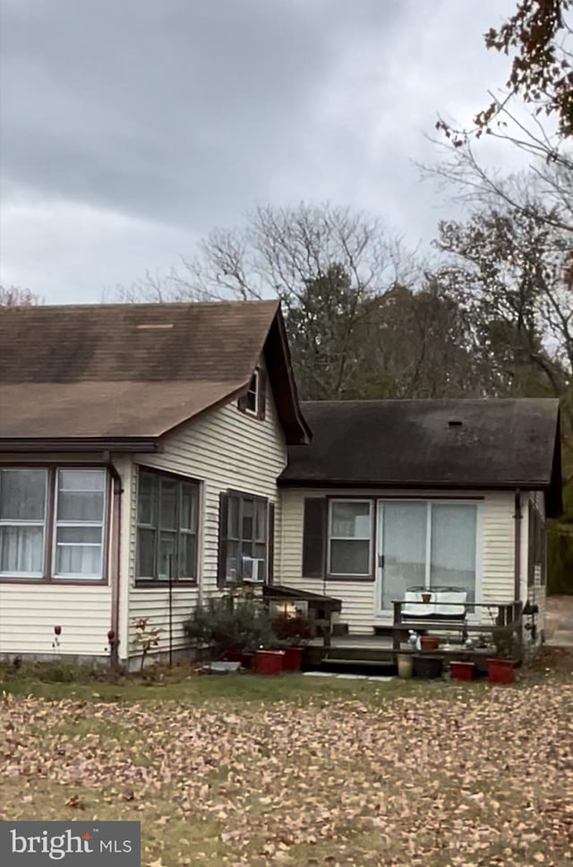 rear view of house with cooling unit