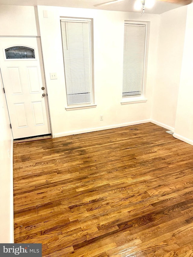 spare room with dark wood-type flooring