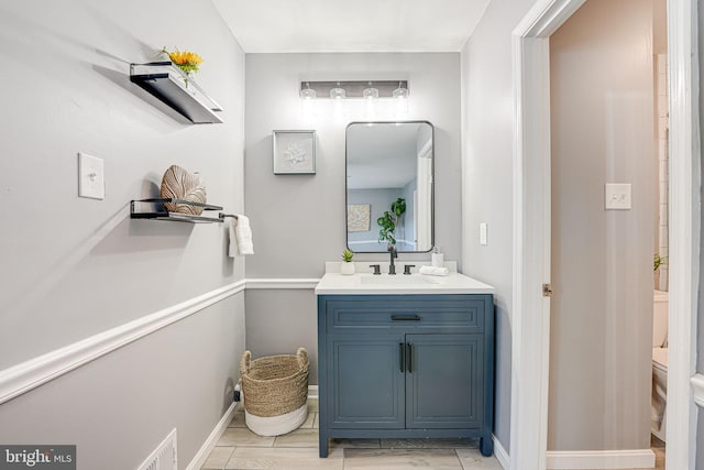 bathroom featuring vanity and toilet