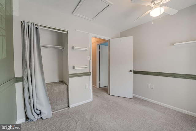 unfurnished bedroom with light colored carpet, ceiling fan, and a closet