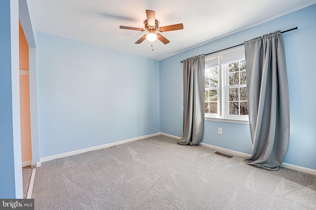 unfurnished room featuring light colored carpet and ceiling fan