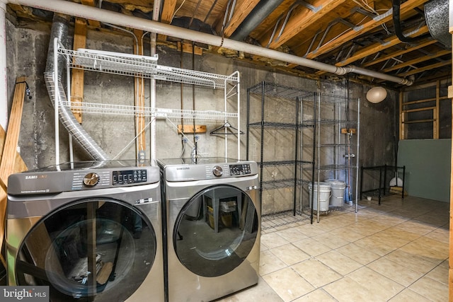 laundry area with tile patterned flooring and separate washer and dryer