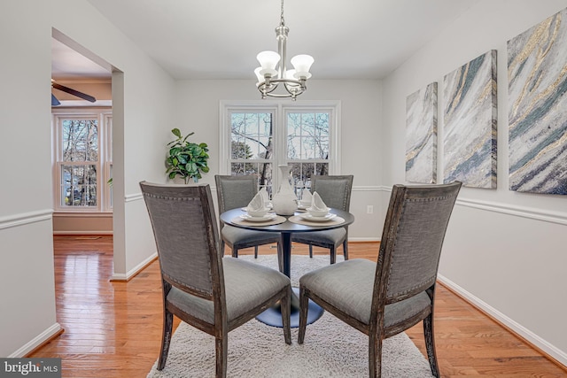 dining room with wood-type flooring and a chandelier