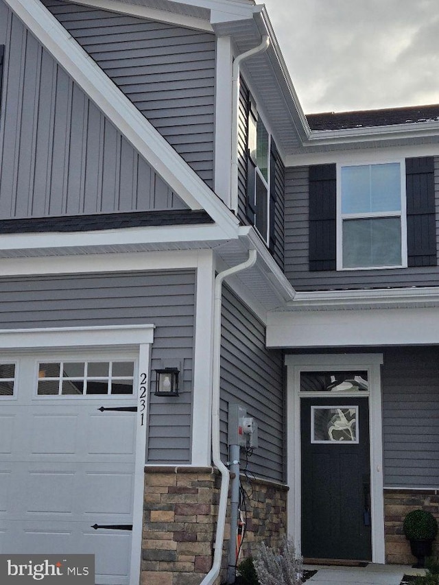 doorway to property with a garage