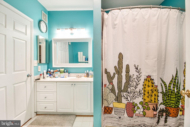 bathroom with tile patterned floors, vanity, and curtained shower