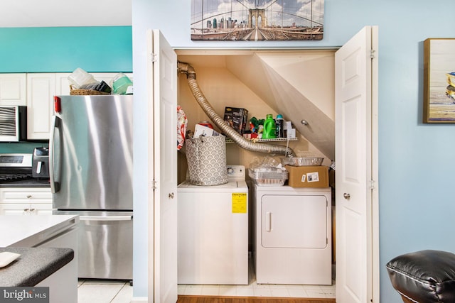 clothes washing area featuring separate washer and dryer