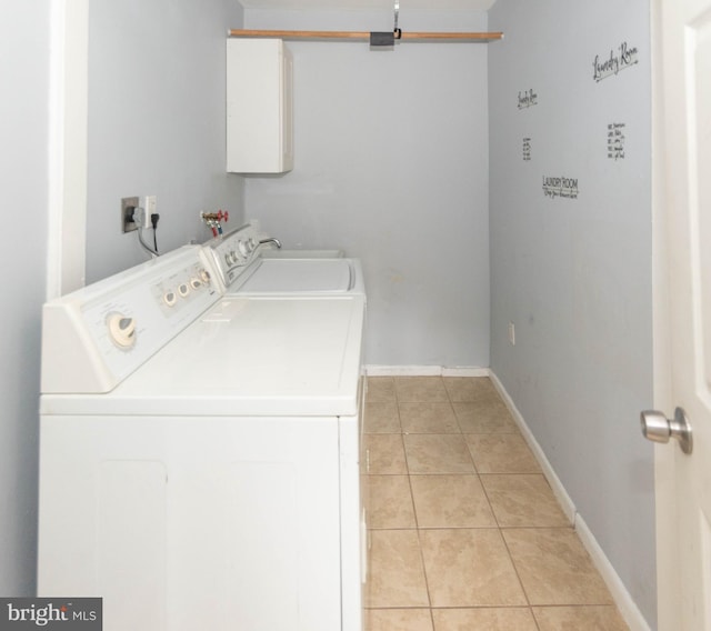 washroom featuring washing machine and clothes dryer and light tile patterned floors