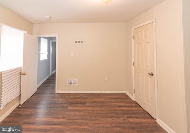 spare room with dark hardwood / wood-style floors