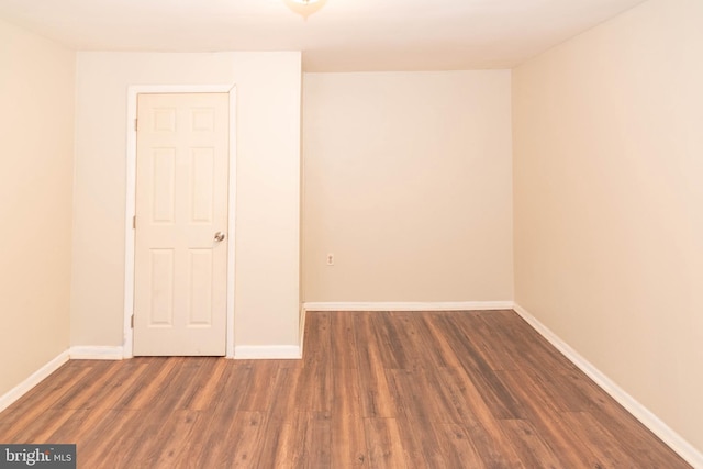 empty room with dark hardwood / wood-style floors