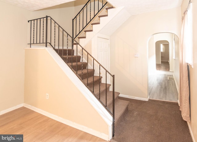 staircase with wood-type flooring