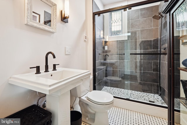 bathroom featuring toilet and walk in shower