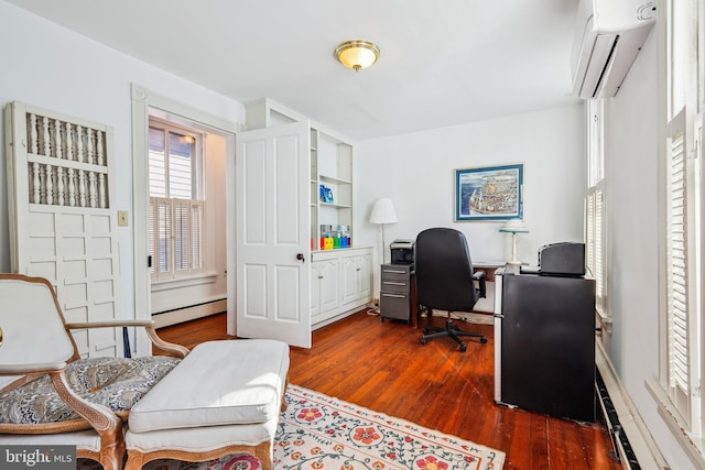 office space featuring dark hardwood / wood-style flooring, an AC wall unit, baseboard heating, and built in shelves