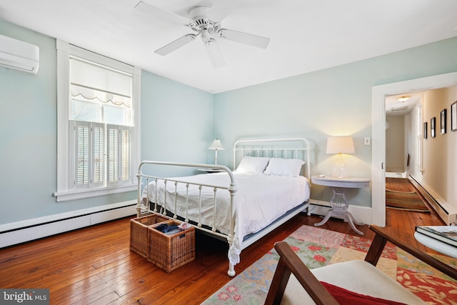 bedroom with a baseboard heating unit, a wall mounted AC, ceiling fan, and dark hardwood / wood-style flooring