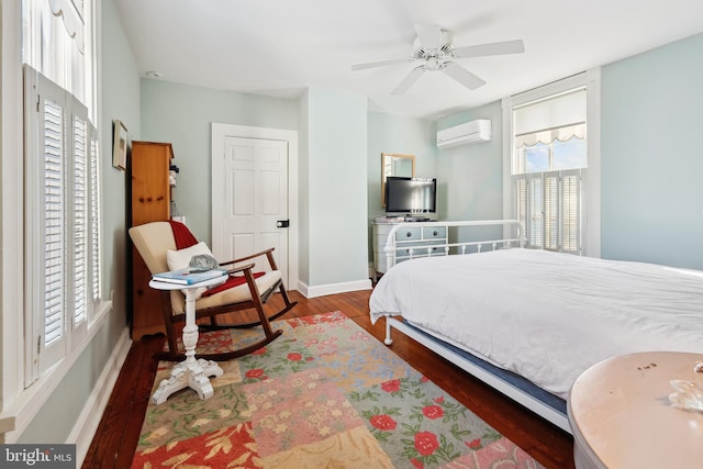 bedroom featuring an AC wall unit, ceiling fan, and dark hardwood / wood-style floors