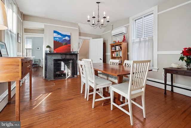 dining room featuring an AC wall unit, a notable chandelier, and dark hardwood / wood-style floors