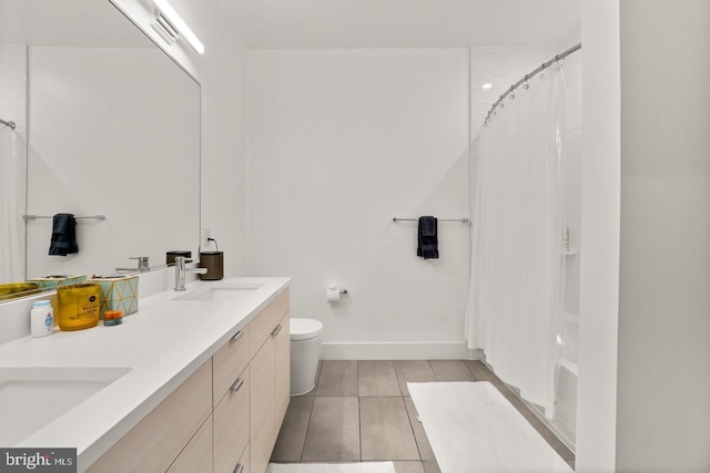 bathroom with tile patterned floors, curtained shower, vanity, and toilet