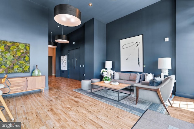 interior space with a high ceiling and wood-type flooring