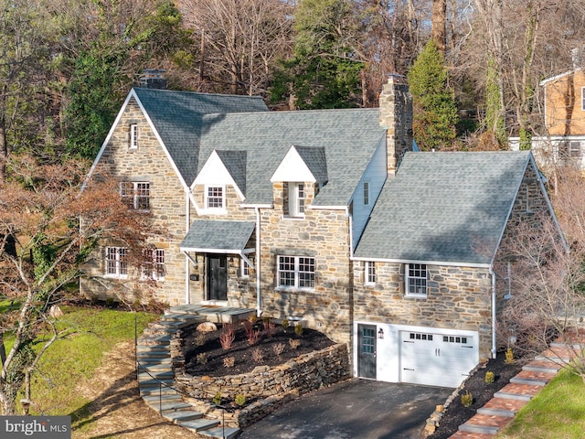 tudor house featuring a garage