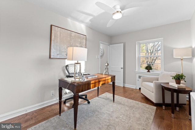 home office with ceiling fan and dark hardwood / wood-style floors