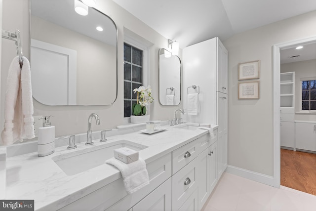 bathroom featuring tile patterned flooring and vanity