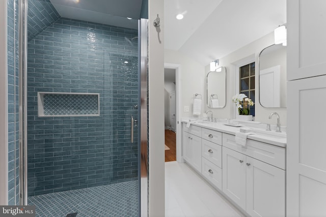 bathroom featuring tile patterned flooring, vanity, and walk in shower