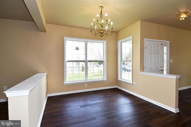 unfurnished dining area featuring a notable chandelier, dark hardwood / wood-style floors, and beam ceiling