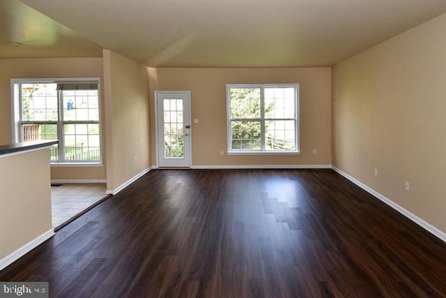 unfurnished room with dark hardwood / wood-style flooring