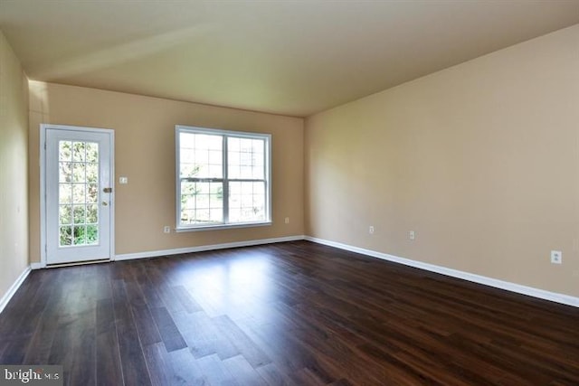 spare room with dark hardwood / wood-style floors