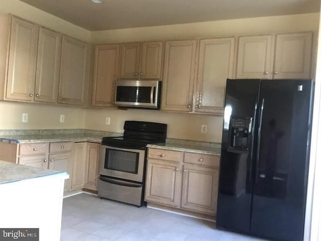 kitchen with light brown cabinetry and stainless steel appliances