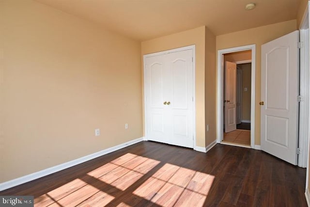 unfurnished bedroom with dark hardwood / wood-style floors