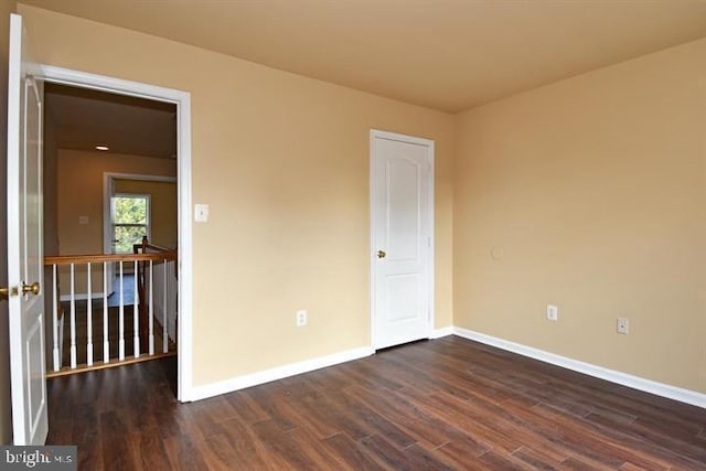 empty room featuring dark wood-type flooring