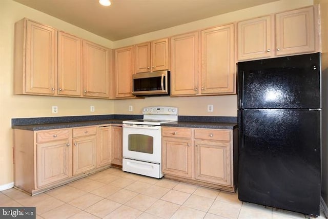 kitchen with electric range, black refrigerator, light tile patterned flooring, and light brown cabinetry