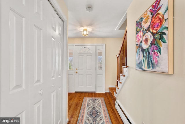 foyer with a baseboard heating unit and hardwood / wood-style flooring