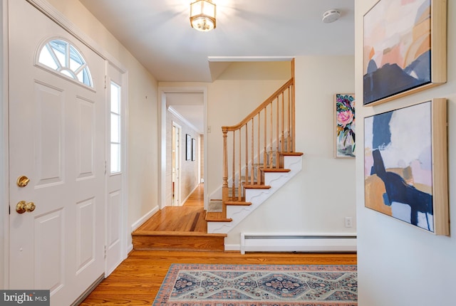 entryway with a baseboard radiator and hardwood / wood-style floors