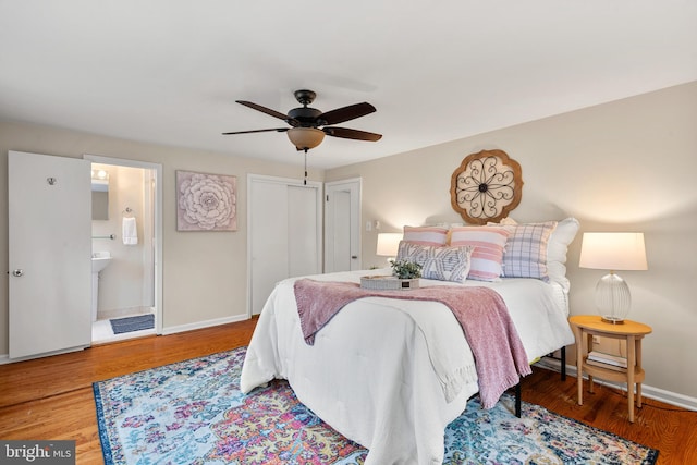 bedroom featuring ensuite bathroom, hardwood / wood-style floors, and ceiling fan