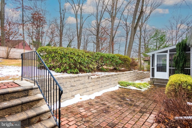 view of patio with a sunroom