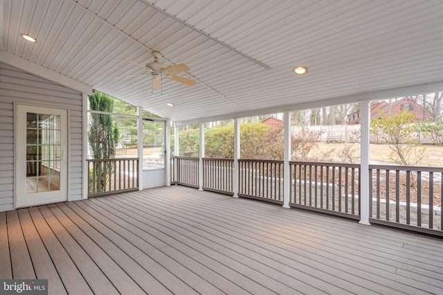 unfurnished sunroom featuring ceiling fan