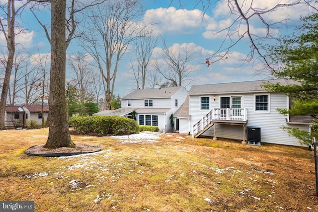 back of house featuring a yard, a deck, and central air condition unit