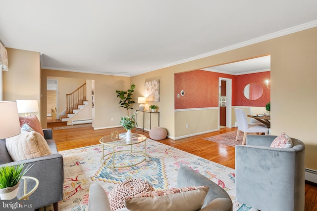 living room with hardwood / wood-style floors, a baseboard heating unit, and ornamental molding