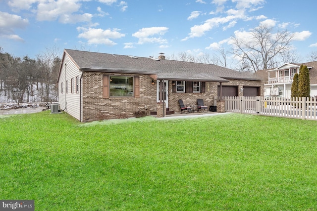 single story home with cooling unit, a front lawn, and a garage