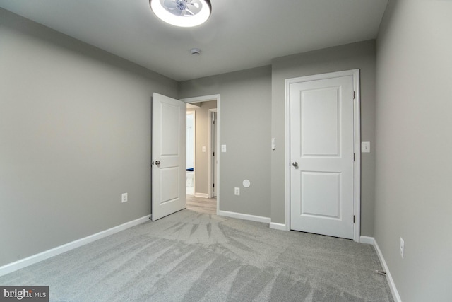 unfurnished bedroom with light colored carpet