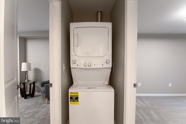 laundry area with light colored carpet and stacked washer and clothes dryer