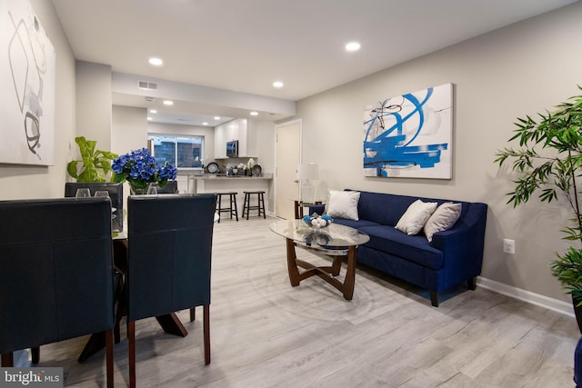 living room with light hardwood / wood-style flooring