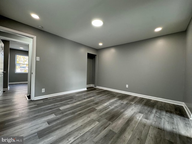 spare room featuring dark wood-type flooring