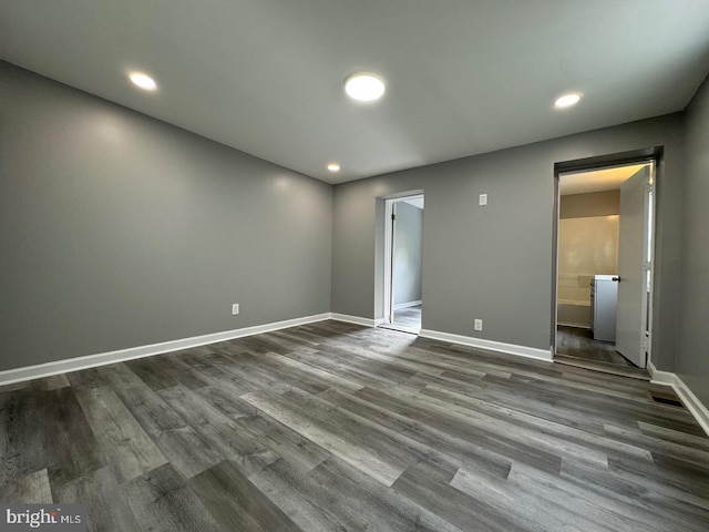 spare room featuring dark wood-type flooring