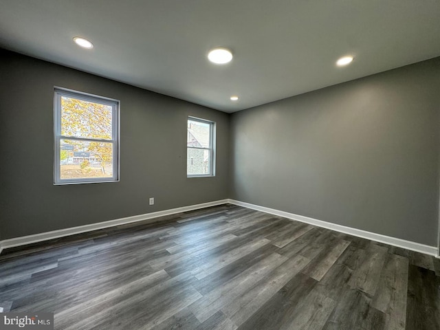 unfurnished room featuring dark wood-type flooring